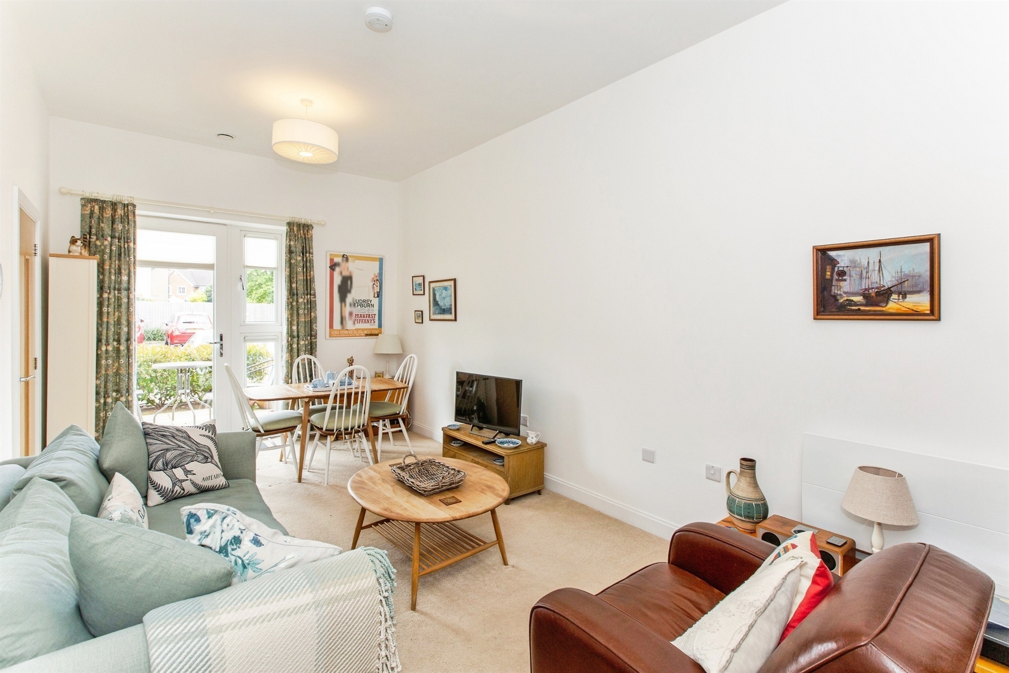 Lounge and dining area with patio doors at 10 Uplands Place, Cambourne